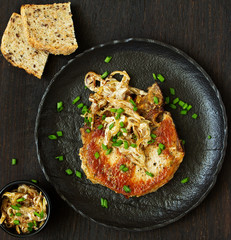 Fried pork steak with broccoli and onion sauce.