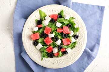 Plate with delicious watermelon salad on table
