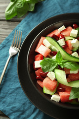 Plate with delicious watermelon salad on table, closeup