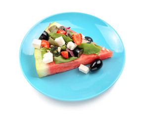 Plate with slice of watermelon and tasty salad on white background