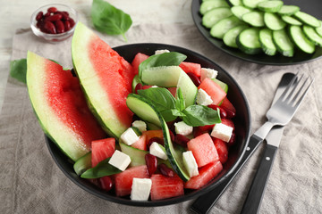 Plate with delicious watermelon salad on table