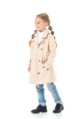 adorable child posing in autumn beige coat, isolated on white