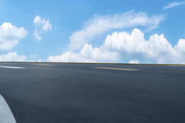 Road pavement under blue sky and white clouds