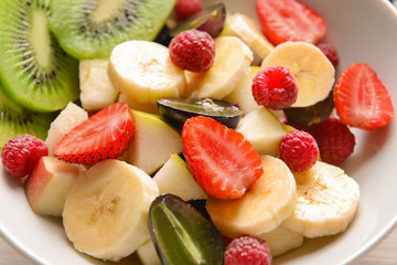 Bowl with tasty fruit salad, closeup
