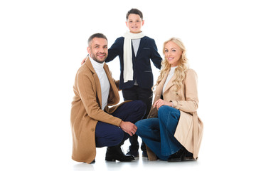 Fototapeta premium happy family hugging with son in autumn outfit, isolated on white