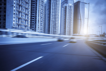 Road pavement and city building skyscrapers