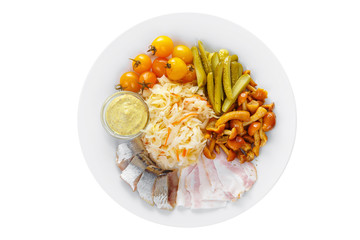 Cold appetizer before alcohol, food, sauerkraut, pickled cucumbers, tomatoes, mushrooms, honey agarics, lard, herring, mustard on plate, white isolated background view from above For the menu