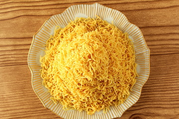 traditional indian gujrati tea time snack food namkeen sev or vermicelli fry noodles of chickpea flour or besan © gv image