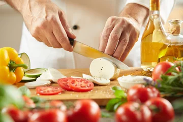 Fotobehang Chef cutting fresh cheese with tomatoes © exclusive-design