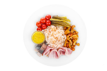 Cold appetizer before alcohol, food, sauerkraut, pickled cucumbers, tomatoes, mushrooms, honey agarics, lard, herring, mustard on plate, white isolated background view from above For the menu