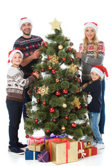 happy family decorating christmas tree with presents, isolated on white