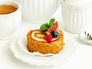 a piece of carrot cake with berries.