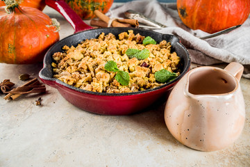 Homemade autumn pastries, pumpkin crumble pie in a cast-iron frying pan, light stone background, copy space top view