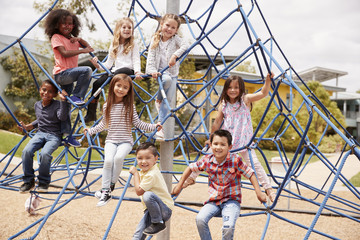 Elementary school kids climbing in the school playground