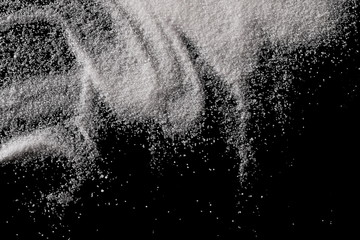 Salt isolated on black background, top view