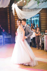 Fototapeta premium First wedding dance of newlywed couple in restaurant