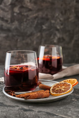 Glass of delicious mulled wine on metal tray