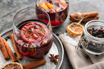 Glass of delicious mulled wine on metal tray