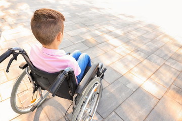 Boy in wheelchair outdoors