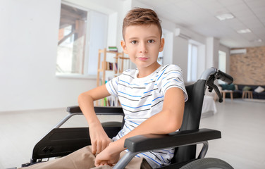 Handicapped boy in wheelchair at home