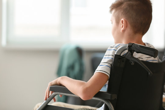 Handicapped Boy In Wheelchair At Home