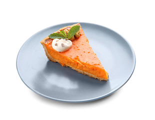 Plate with piece of tasty pumpkin pie on white background