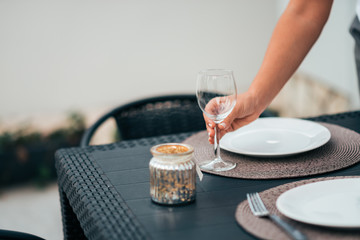 Preparing table for dinner at home.