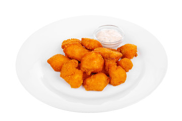 Hot appetizer chicken nuggets in crispy golden breadcrumbs, fried in oil, mayonnaise sauce, tar-tar, before alcohol, on plate, white isolated background Side view. For the menu, restaurant, cafe