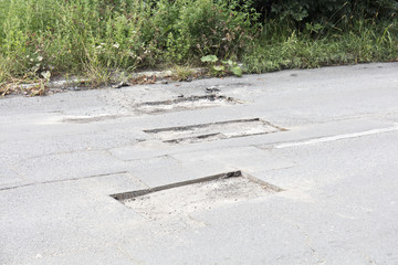 bad asphalt road, repair of asphalt road, pit on the road
