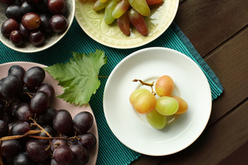 Different types of sweet grapes on table