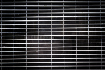 A top and close-up view of a metal grid. Industry and texture as a concept 
