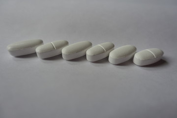 Calcium citrate nutritional supplement tablets in a row
