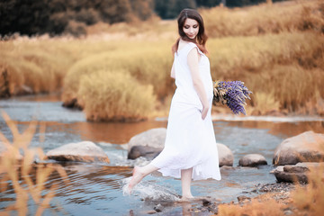 Pregnant woman in nature for a walk in the autumn