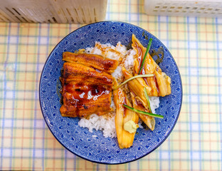 Eel Kabayaki grilled with raw tuna on rice in blue bowl
