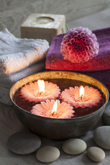 Fototapeta na wymiar Decorative spa still life with candles, soap, flower and towels, perfect for spa, well-being, beauty and relaxation themes