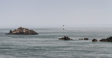 Beautiful view the ocean and lighthouse at Pointe du Grouin near Cancale in Brittany, France, in summer
