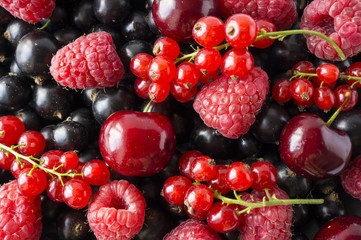 Ripe blackcurrants, cherries, red currants, raspberries. Mix berries and fruits. Top view. Background berries and fruits. 