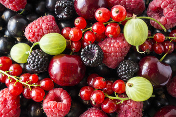 Ripe blackberries, blackcurrants, cherries, red currants, raspberries and gooseberries. Mix berries and fruits. Top view. Background berries and fruits. 