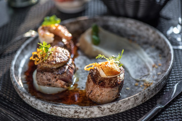 Grilled steak meat with foie gras, shrimp and cheese