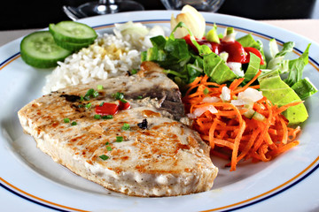 Grilled sword fish steak with vegetables, shallow focus
