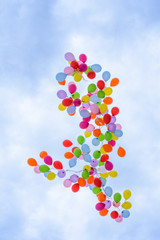 Group of multicolored helium filled balloons in the sky