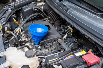 Fototapeta premium Close-up Synthetic change oil box in engine front