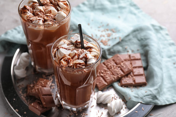Glasses of hot chocolate with marshmallows on metal tray