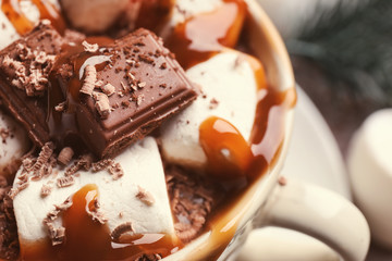 Cup of hot chocolate with marshmallows and caramel, closeup