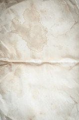 Background texture of crumpled aged paper with spot and stain