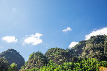Obraz premium Mountain peak range landscape. Green mountain range view. Mountain peak blue sky white clouds panorama