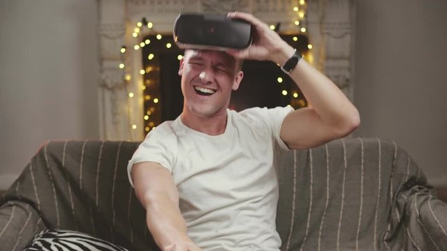 Young man winning racing game, being excited