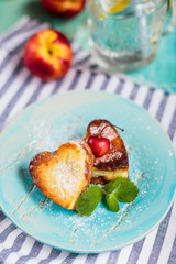 Cupcakes in the form of heartson the blue background