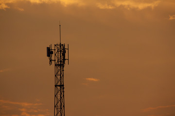 Silhouette of Signal tower with golden sky background.