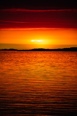 Reflection of the setting sun on the low cloud cover, on the Island of Aspö in Archipelago National Park (Skärgårdshavet nationalpark), Finland, 4 days after the summer solstice.